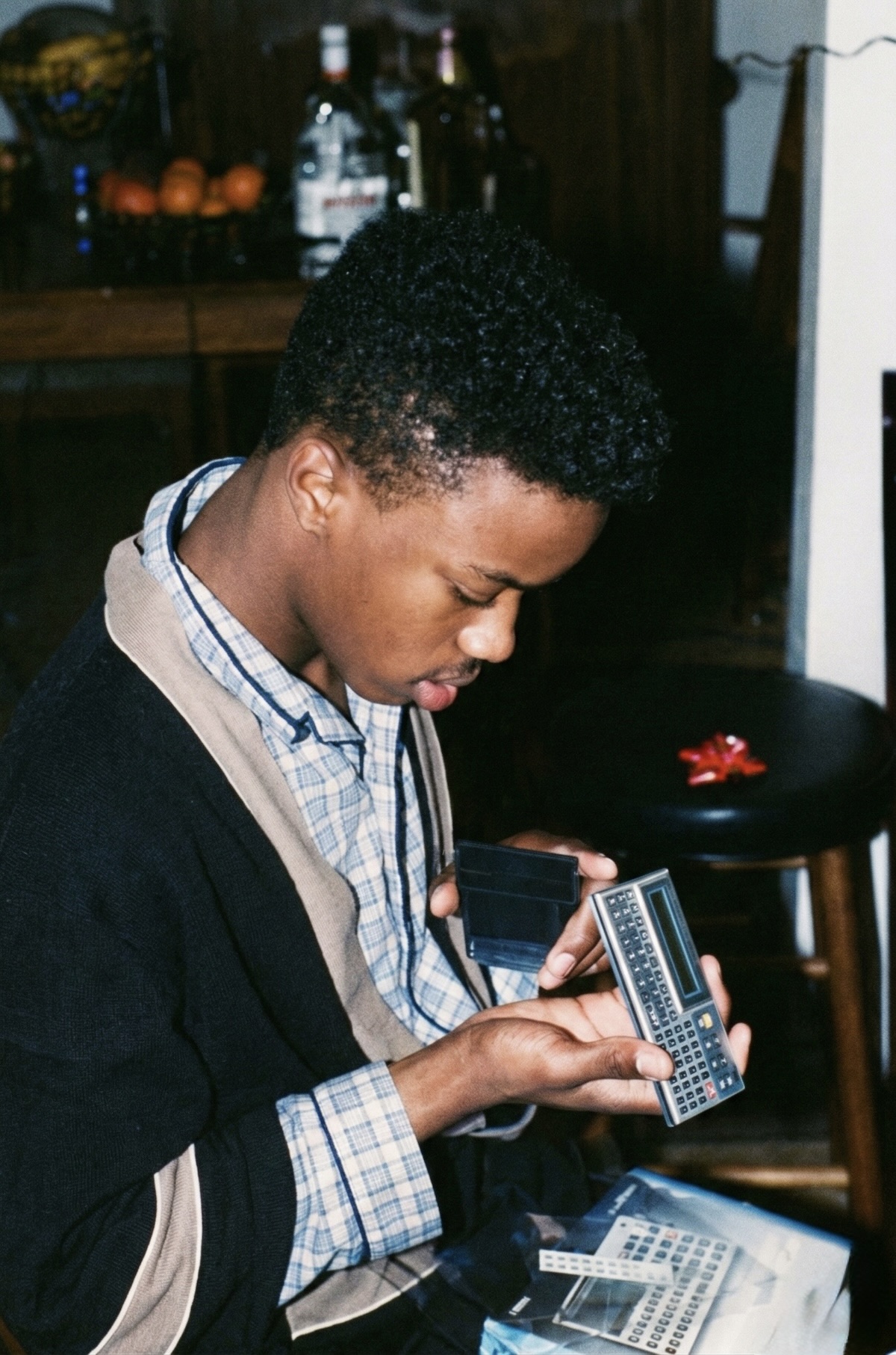 Young Frederick Van Johnson unboxing a Casio programmable calculator, Willingboro, New Jersey