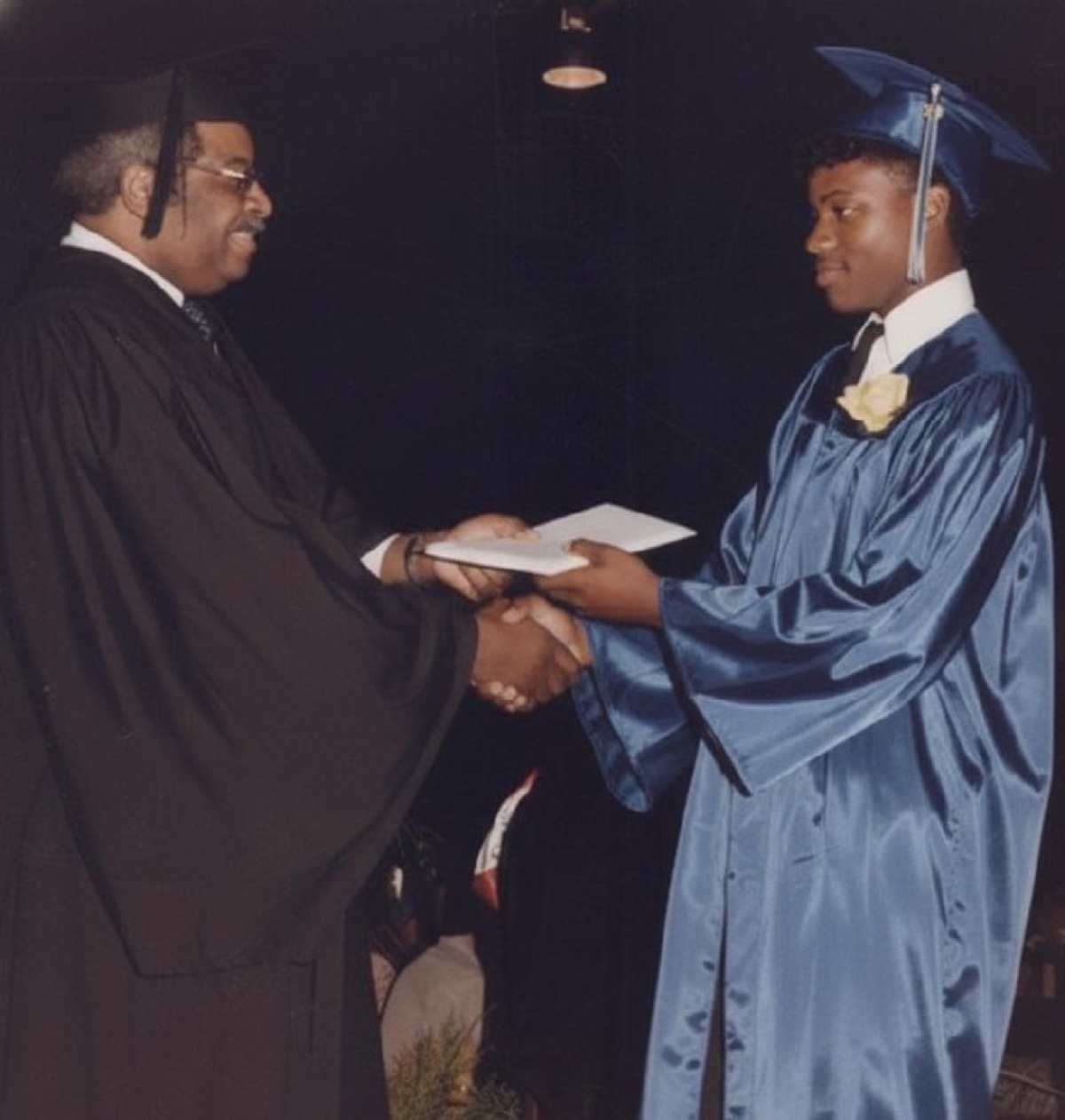 Frederick Van Johnson receiving diploma at Crete-Monee High School graduation, June 1988