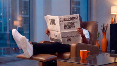 Frederick Van Johnson reading a newspaper